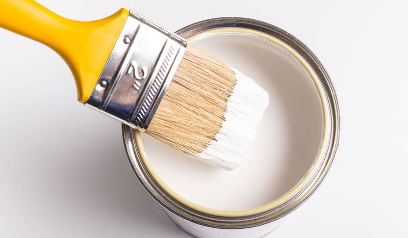 Paint brush in paint can